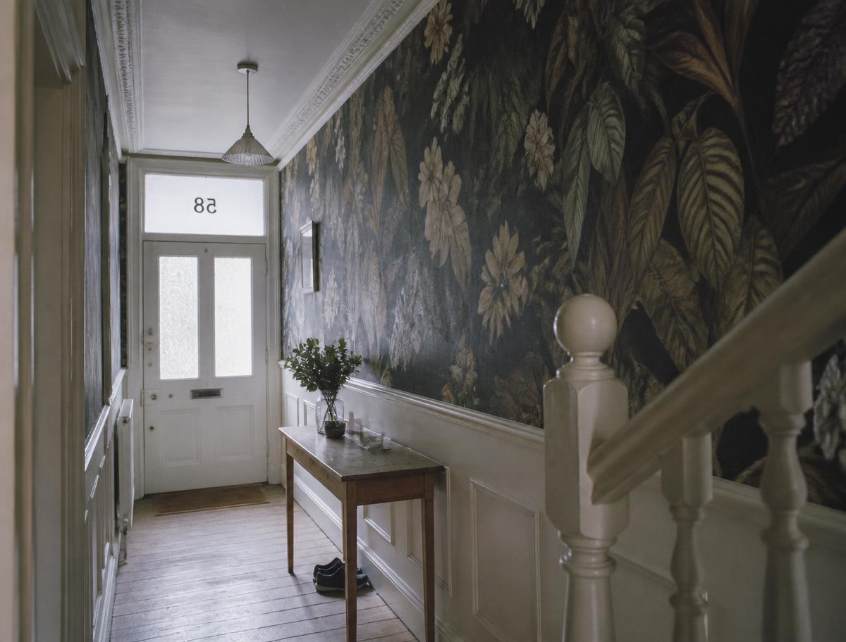 Panelled hallway with a mural wallpaper and console table